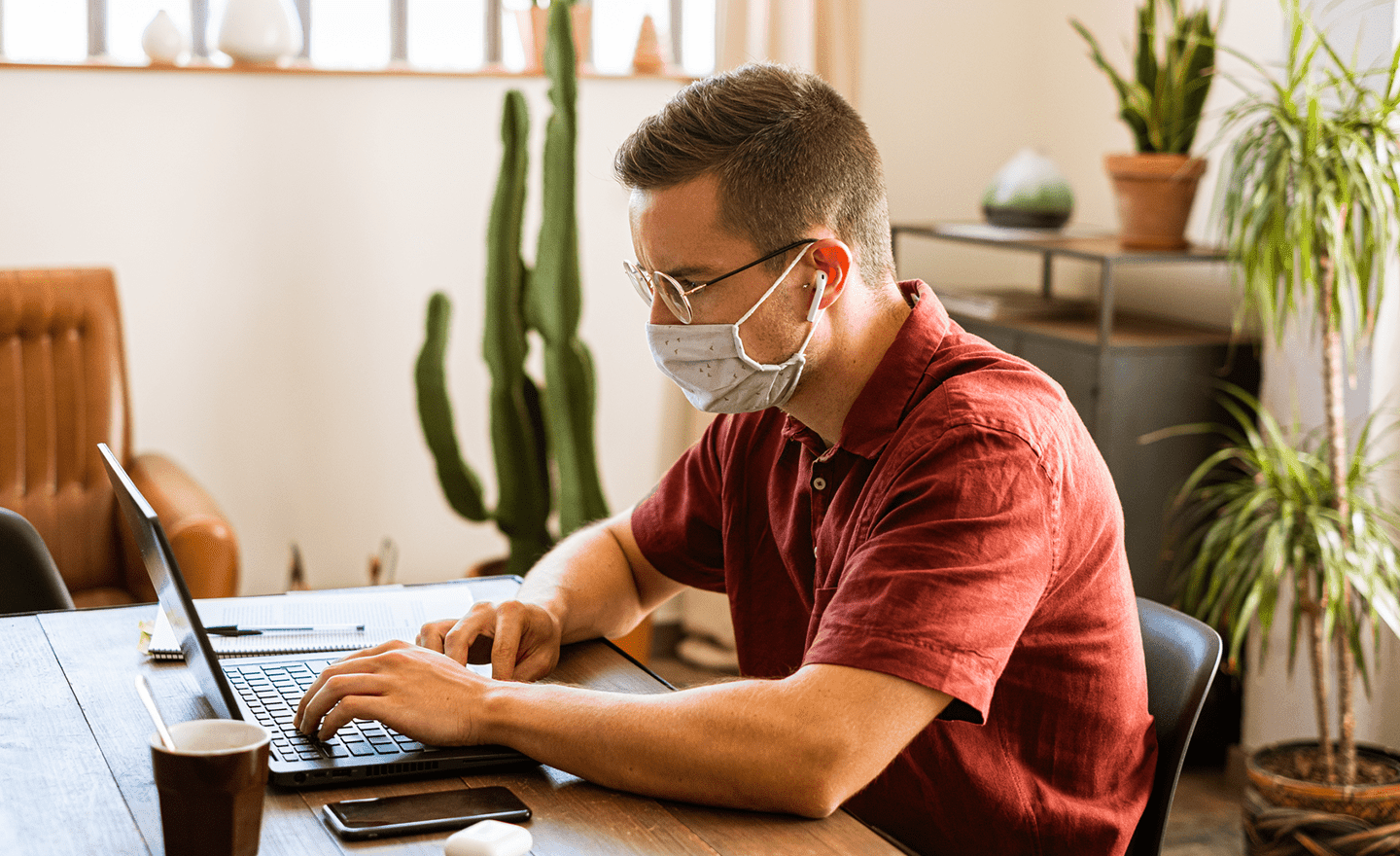 Man working from coworking space on laptop